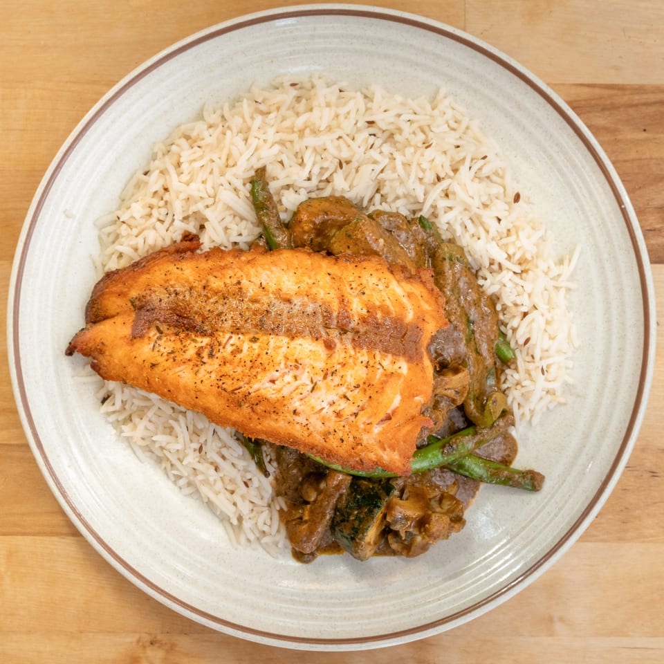 B'Gabs Comfort Cafe's healthy salmon dish with rice, green beans, and gravy on a plate.
